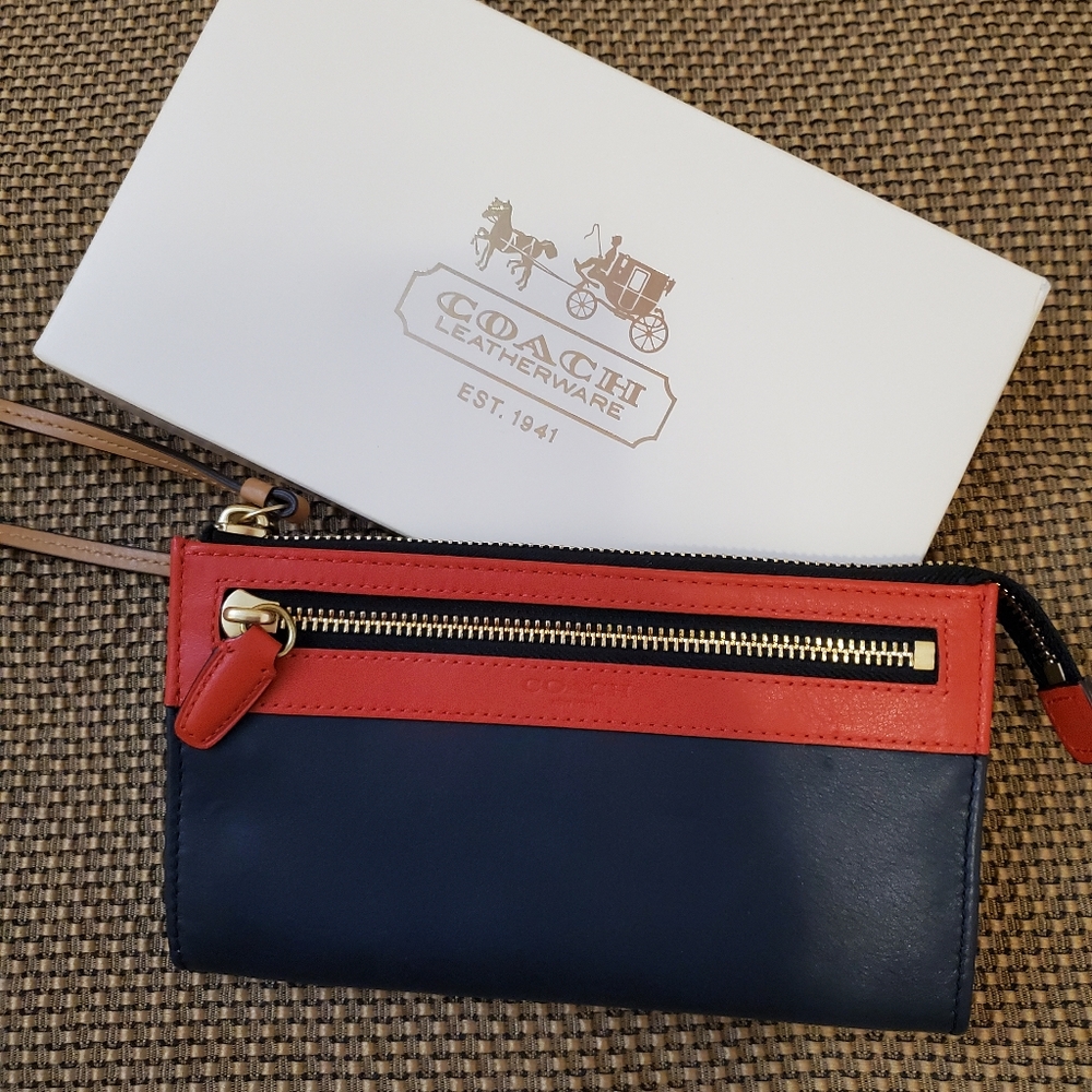 COACH orange and navy leather wristlet